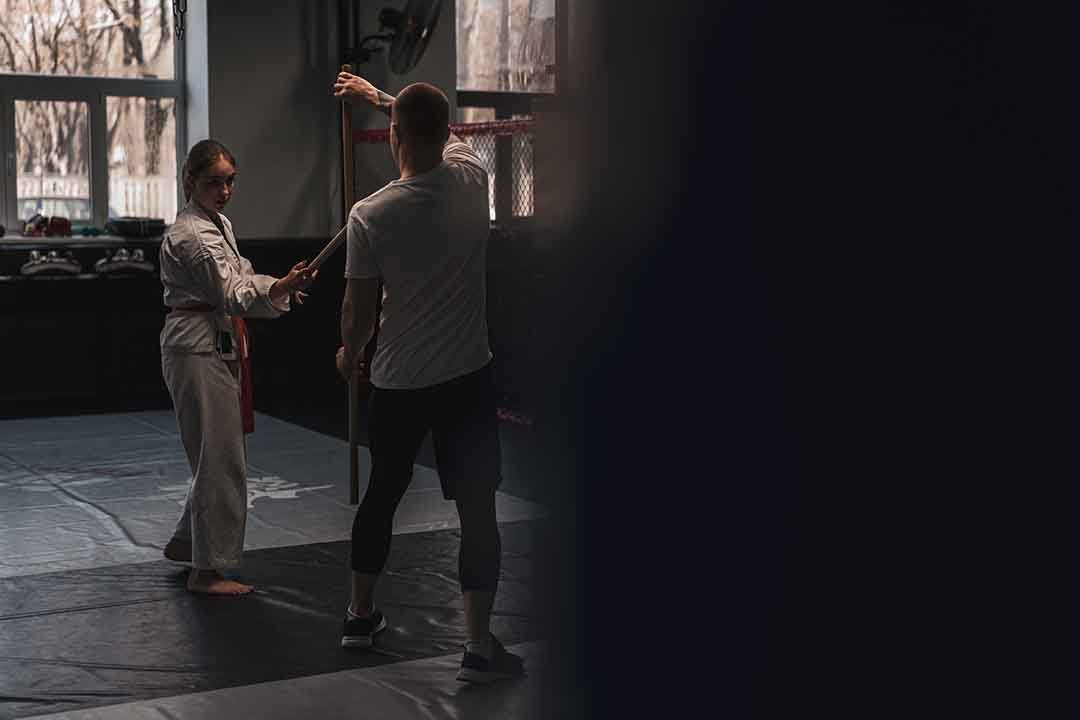 Two fighters practicing with wooden sword in Aikido Sport and ma